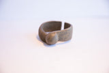 Side profile of a vintage African cuff, highlighting its opening and hand-etched designs.
