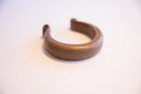 Angled view of the hand-etched markings on the heavy antique African cuff bracelet.