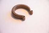 The substantial form and scrolled ends of an antique heavy cuff bracelet.