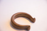 Detailed view of the antique cuff's textured surface and rich, time-worn patina.