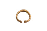 Vintage African bronze cuff bracelet with a thick, rounded form and textured details.