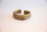 Angled profile of a vintage bronze cuff showing its handcrafted braided texture.