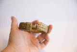 The opening of the vintage African bronze cuff, detailing its textured ends.