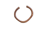 Vintage African copper alloy cuff bracelet with a warm, textural patina and hand-carved details.