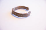 Side profile of the vintage African cuff showing its curved form and etched details.