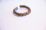 Side view of the antique African twist cuff's rustic, oxidized metal texture.