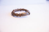 Smooth, rounded ends forming the opening of the antique African twist cuff.