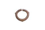 Antique African bronze cuff bracelet with textured diagonal lines and a dark, aged patina.