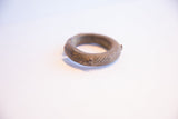 Close-up of the antique bronze cuff's handcrafted texture and rich aged patina.