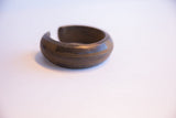 Antique African heavy cuff bracelet showing its open profile and textured craftsmanship.