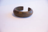 The substantial opening and thick profile of an antique African cuff bracelet.
