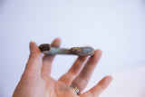 Aged patina and surface wear on the thick, rounded tip of the African cuff.