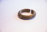Aged patina and hand-carved texture on a vintage bronze alloy bracelet.
