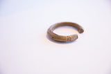 Side view of the vintage bronze cuff highlighting its etched details and C-shape opening.