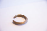 Open end of the vintage bronze cuff highlighting its handcrafted texture and patina.