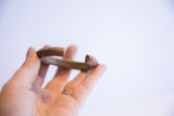 View of the open ends of the vintage bronze cuff, showing its thick form and aged patina.