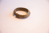 Side view of the vintage bronze cuff highlighting its opening and aged, etched patina.