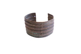 Vintage African oxidized wide cuff bracelet with horizontal ridges and an aged patina.