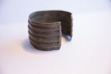 Side profile of the wide African cuff bracelet highlights its ribbed, oxidized metal.