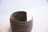 Oxidized ridges and the curved opening of the handmade African cuff bracelet.