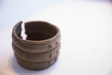 The opening of the wide African cuff, showing the bracelet's solid form and texture.
