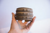 Vintage African wide cuff bracelet with a textured surface, held in hand for scale.