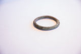 Hand-etched details and aged green patina on a vintage African bracelet.