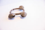Angled view of the vintage Lobi bell cuff's open design and rough, oxidized metal texture.
