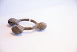 Angled view of the oxidized Lobi bell cuff's open design and textured surface.