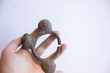 Vintage Lobi bell cuff held to show its scale, open shape, and oxidized texture.