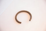 Aged patina and fine, linear texture on a handmade African copper alloy cuff.