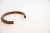 Close-up of the solid, flat-faced terminal on the vintage African copper alloy cuff.