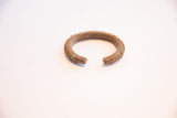 Open ends of the vintage ribbed African cuff showing its aged metal finish.