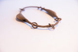 Detail of the handmade links and aged patina on the vintage Yoruba rattle bracelet.