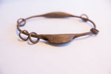 Detailed view of the handcrafted rattle and metal rings of the vintage Yoruba bracelet.