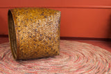 Gigantic antique Asian hand woven bamboo basket with varied brown diagonal weave.