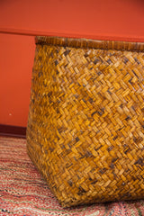Intricate hand-woven texture of the vintage Asian bamboo basket, golden brown tones.