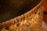 Intricate hand woven bamboo basket rim with its tightly bound edge and natural tones.