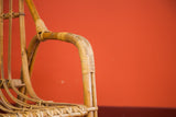 Curved natural rattan armrest with tightly woven details, Mid Century Modern chair.