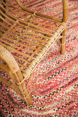 Mid Century Modern rattan chair's curved woven frame and wrapped joints.
