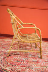 Bent rattan legs and wrapped joints of the Mid Century Modern chair.