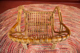 Overhead view of the rattan chair's intricately woven back and slatted seat construction.