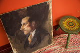 Vintage Aucello oil portrait on board, showcasing the dark palette and raw edges.