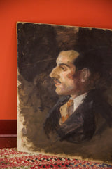 Lower corner of the vintage Aucello oil portrait, showing dark paint texture and board edge.