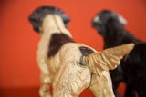 Rear view of the vintage pointer dog doorstop, highlighting its sculpted tail and cream and brown body.