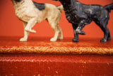 Red woven surface with natural tone basketweave edge, vintage Pointer dog doorstops behind.
