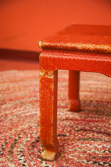 Vintage Chippy Wicker Coffee Table leg detail showing red painted wicker texture and paint loss.