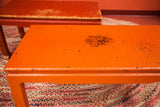 Textured orange wicker tabletop, showing double exposed paint and surface wear.