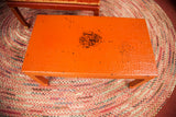 Visible woven texture and paint wear on the vintage orange wicker tabletop.