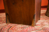 Antique Oversized Settle Chair's lower leg, with minor discoloration on its wood.